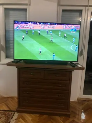 a television on a dresser with a soccer game on it at Champion in Belgrade
