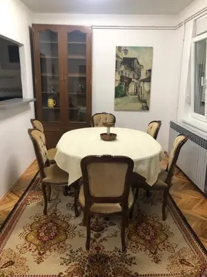 a dining room with a white table and chairs at Champion in Belgrade