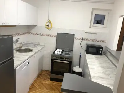 a small kitchen with a sink and a stove at Champion in Belgrade