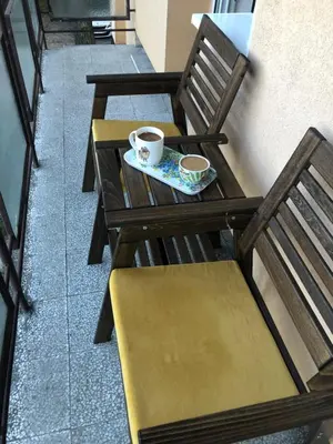 two wooden tables and chairs with coffee cups on them at Champion in Belgrade
