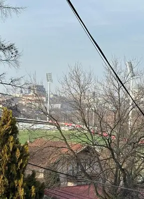 a view of a field with a train in the distance at Champion in Belgrade