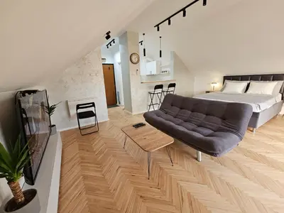 a living room with a bed and a couch at Apartment LUMALU in Belgrade