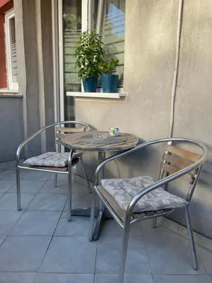 two chairs and a table on a patio at JOVAN APARTMAN in Rospi Ćuprija