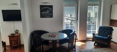 a dining room with a table and chairs and a television at The Bridgeview Suite in Belgrade