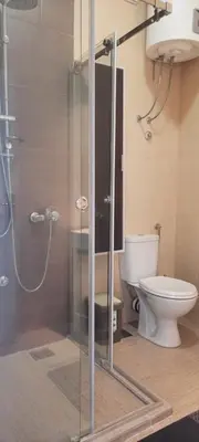 a bathroom with a shower and a toilet at The Bridgeview Suite in Belgrade