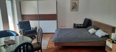 a bedroom with a bed and a table and chairs at The Bridgeview Suite in Belgrade