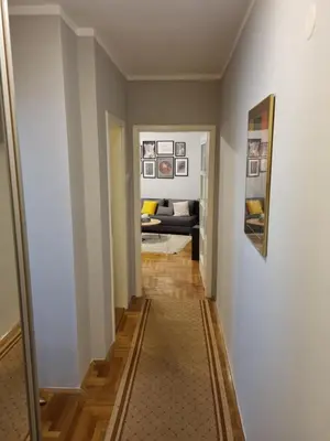 a hallway leading to a living room with a couch at THE FIVE-OLD TOWN Apartments in Belgrade