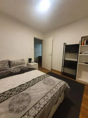 a bedroom with a bed and a book shelf at Art City Center Apartment in Belgrade