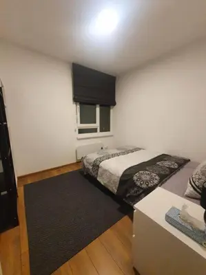 a small bedroom with a bed and a window at Art City Center Apartment in Belgrade