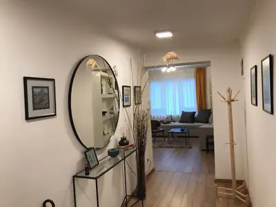 a living room with a mirror on the wall at Art City Center Apartment in Belgrade