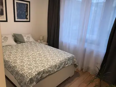 a bedroom with a bed and a window at Art City Center Apartment in Belgrade