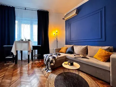 a living room with a couch and a table at Insta-Apt 3min walk to Knez Mihailova Renovated in Belgrade