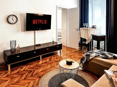 a living room with a television on a wall at Insta-Apt 3min walk to Knez Mihailova Renovated in Belgrade