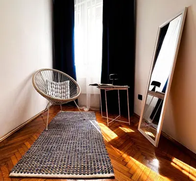 a room with a mirror and a chair and a rug at Insta-Apt 3min walk to Knez Mihailova Renovated in Belgrade