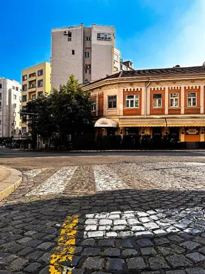 a cobblestone street in front of a building at Insta-Apt 3min walk to Knez Mihailova Renovated in Belgrade