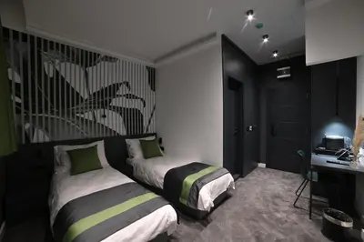 a bedroom with two beds and a desk in it at City Joy - sports Center Tasmajdan in Belgrade