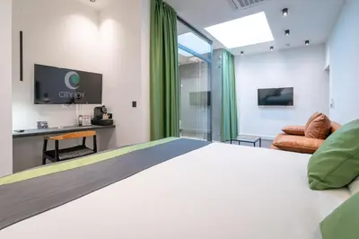 a hotel room with a bed and a tv at City Joy - sports Center Tasmajdan in Belgrade