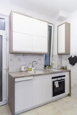 a kitchen with white cabinets and a sink at Balkan dream **** in Belgrade