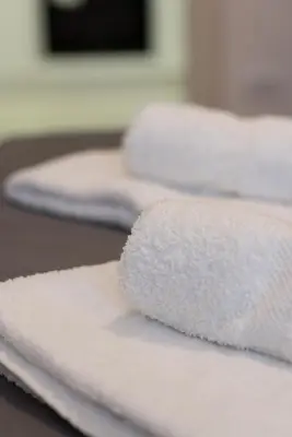 a pile of white towels sitting on top of a table at Balkan dream **** in Belgrade
