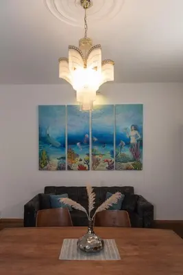 a dining room with a table with a chandelier at Balkan dream **** in Belgrade