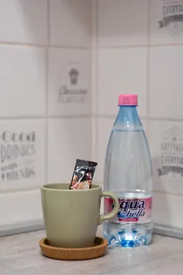 a cup and a bottle of water on a counter at Balkan dream **** in Belgrade