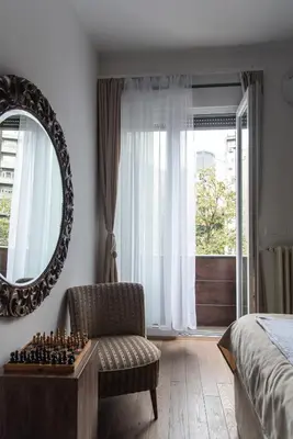 a bedroom with a chess board and a mirror at Balkan dream **** in Belgrade