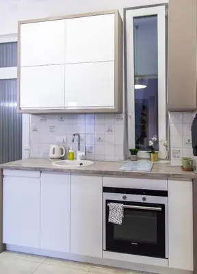a kitchen with white cabinets and a sink at Balkan dream **** in Belgrade