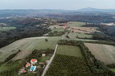 an aerial view of a field with houses and trees at Uzivancija in Lazarevac