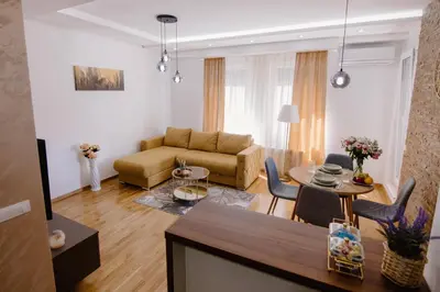 a living room with a couch and a table at Cherry Lux Apartments in Arandjelovac