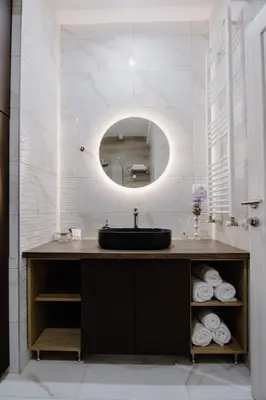 a bathroom with a sink and a mirror at Cherry Lux Apartments in Arandjelovac