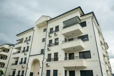 an apartment building with balconies on the side of it at Cherry Lux Apartments in Arandjelovac