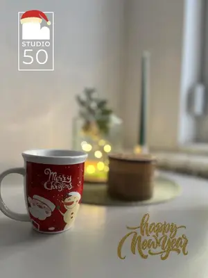 a red christmas coffee cup sitting on a counter at Studio 50 in Belgrade