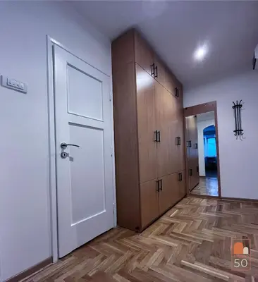 a room with a white door and wooden cabinets at Studio 50 in Belgrade