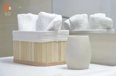 a wooden basket with towels and a vase on a counter at Studio 50 in Belgrade