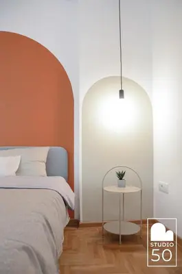 a bedroom with a bed and a table with a lamp at Studio 50 in Belgrade