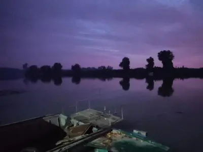a boat in a body of water at dusk at Vikendica Tisa Dukatar in Titel
