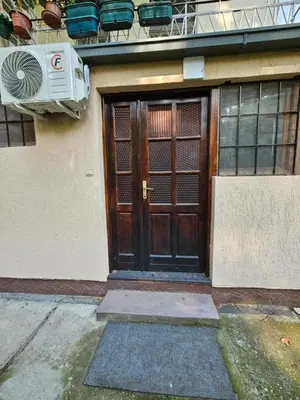 a wooden door on a building with a balcony at Booking Apartments Alone 1 in Belgrade