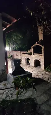 a stone oven in a yard at night at Miljakovački konak in Belgrade