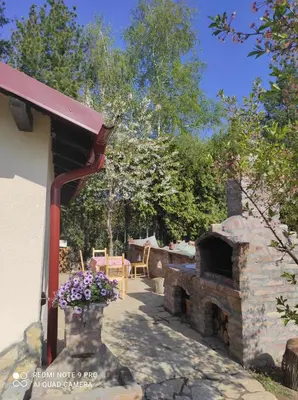 a patio with a stone oven in a yard at Miljakovački konak in Belgrade