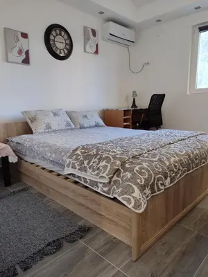 a bed with a wooden frame in a bedroom at Miljakovački konak in Belgrade