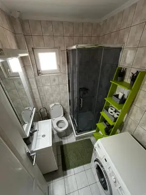 a small bathroom with a washing machine in it at Apart Zen House in Borča