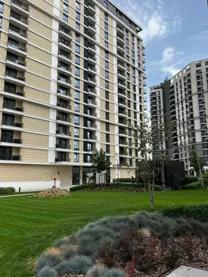 a large apartment building with a park in front of it at DM apartman Belgrade Waterfront in Sajmište