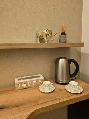a wooden shelf with a tea pot and an elephant on it at DM apartman Belgrade Waterfront in Sajmište
