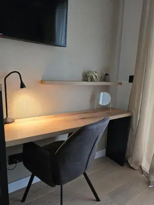 a desk with a chair and a mirror on it at DM apartman Belgrade Waterfront in Sajmište