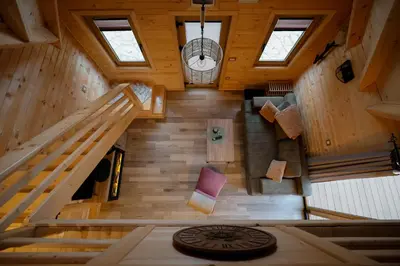 an overhead view of a cabin with wooden walls and wooden stairs at Vila Banstolija in Velika Remeta