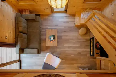 an overhead view of a living room with wood floors at Vila Banstolija in Velika Remeta