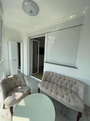 a living room with a couch and a table at Apartman Aranđelovac in Arandjelovac