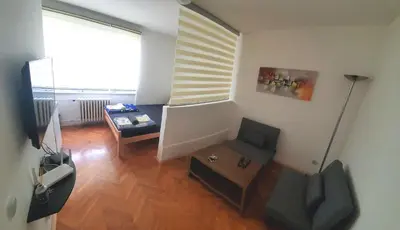 a living room with a chair and a table at Zvezdara in Belgrade