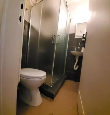 a bathroom with a toilet and a shower and a sink at Zvezdara in Belgrade