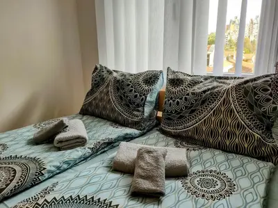 a bed with pillows and towels on top of it at Studio Bajka in Kanarevo Brdo
